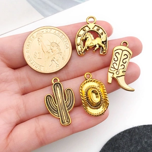Detailed view of four golden western alloy charms featuring horse and cactus for DIY jewelry