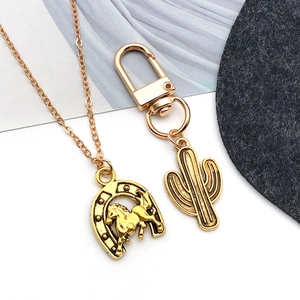 Golden horseshoe and cactus charms on antique finish necklace and keychain set