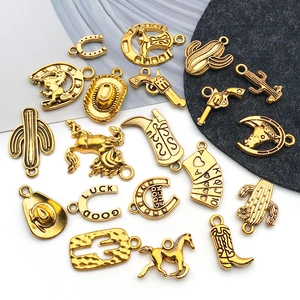 Detailed close-up of golden western cowboy alloy charms including hat and cactus