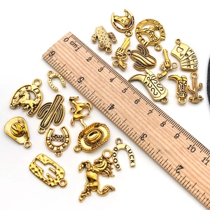 Detailed macro view of Western-themed alloy charms with a ruler for size reference