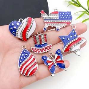 Red white and blue US flag themed charms including heart and star shapes held in hand