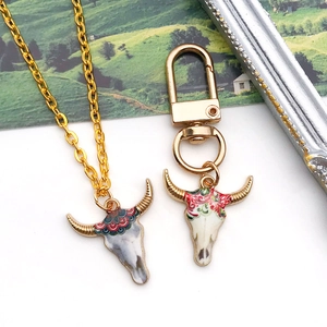 Tribal bull skull pendant necklace and keychain set with colorful floral patterns