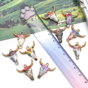 Nine colorful enamel bull skull charms in Bohemian style for DIY jewelry making and crafts