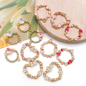 Detail view of pearl and enamel heart floral pendants for DIY jewelry making
