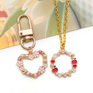 Floral heart and circular wreath pendants with pink cherry blossoms and pearls