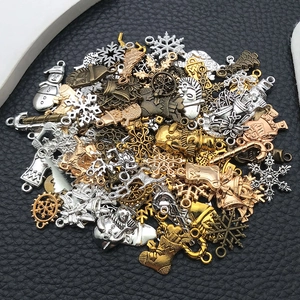 Detailed view of various vintage Christmas alloy charms in silver, gold, and bronze tones