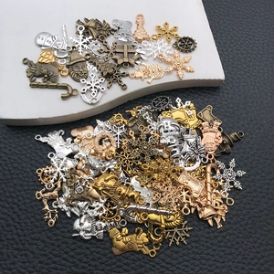 Macro view of Christmas alloy pendants including snowflakes and trees in various metallic finishes