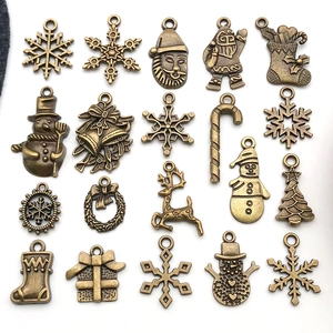 Dettaglio di 20 ciondoli natalizi in bronzo vintage con motivi a fiocco e renna