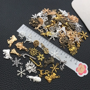 Macro shot of assorted vintage alloy Christmas charms including snowflakes and reindeer