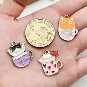 Three enamel cat teacup charms in pink, orange, and purple for DIY jewelry making