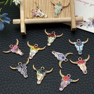 Detailed close-up of colorful bull skull pendants with floral patterns for jewelry making