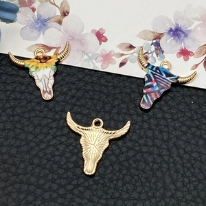 Bull head charms in gold and enamel designs for DIY jewelry making and crafting