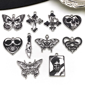 Detailed flat lay of nine gothic style black and white alloy pendants for jewelry making