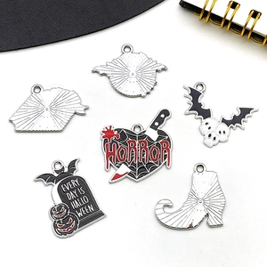 Detail of Halloween enamel charms showing horror dagger heart, tombstone, and skull wings