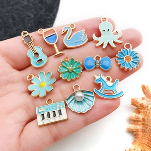 Blue and gold alloy charms set featuring guitar, swan, and octopus shapes for DIY jewelry
