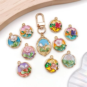 Enamel flower alloy pendants set in various colors with golden oval keychain accessory