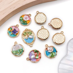 Detailed close-up of colorful enamel flower pendants with gold-plated alloy for DIY jewelry