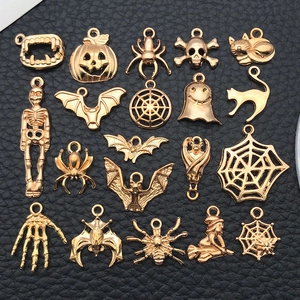 Detailed view of Halloween alloy charms including pumpkins and bats in gold finish