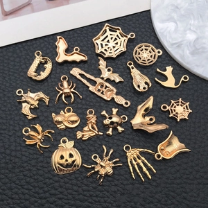 Flat lay of vintage gold Halloween alloy charms including spider bat and pumpkin pendants