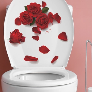 Vintage red rose wall stickers and scattered petals on white toilet lid surface