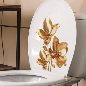 Golden 3D metal floral wall decals for home decor shown on a clean bathroom surface