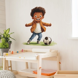 Cartoon boy playing soccer wall decal for kids bedroom decor on white interior wall
