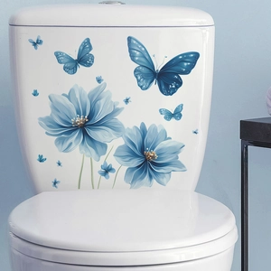 Blue butterfly and flower stickers on white toilet tank for home bathroom decoration