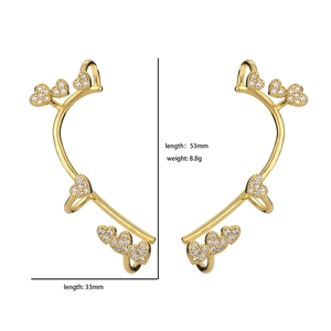 Detailed view of gold heart ear cuffs with pavé cubic zirconia measuring 53mm and 33mm
