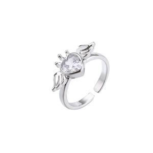 Macro detail of silver adjustable open ring with heart zircon and delicate angel wings
