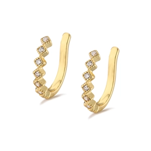 Detail of gold-plated ear cuffs with micro-paved cubic zirconia and beaded edges