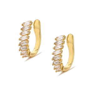 Close-up of gold-plated ear cuffs with baguette-cut cubic zirconia in claw setting