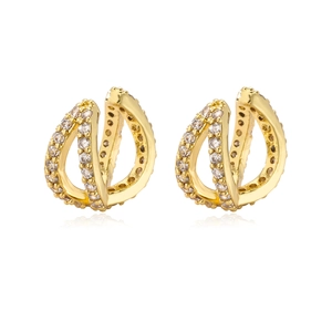 Macro shot of gold-plated multi-layer crisscross ear cuffs with sparkling white cubic zirconia