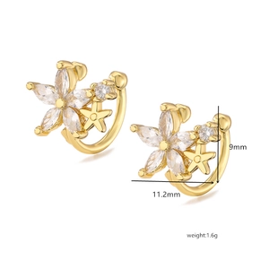 Macro detail of gold flower ear cuffs with marquise zircons showing 9mm by 11.2mm size