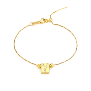 Detail of adjustable 18K gold letter Y bracelet with micro-pocked cubic zirconia