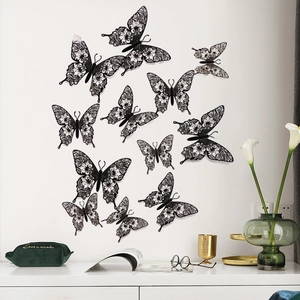 Detailed view of black 3D hollow butterfly wall stickers on a minimalist white background