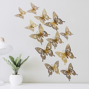 Macro detail of golden 3D hollow butterfly wall stickers with intricate laser-cut patterns