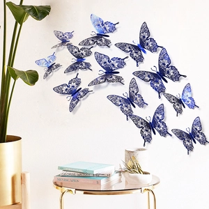 Detail of 12 blue laser-cut 3D butterfly wall stickers with intricate hollow patterns