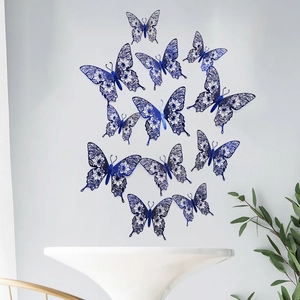 Set of 12 3D hollow blue butterfly wall stickers with floral patterns on a white wall