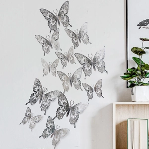 Detail of silver 3D hollow butterfly wall stickers with intricate floral cutout patterns