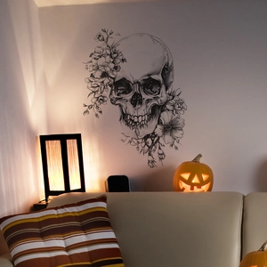 Sketch of gothic skull and floral wall sticker styled in a cozy living room background