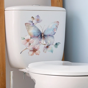 Watercolor blue butterfly and pink floral wall sticker applied on a white toilet tank