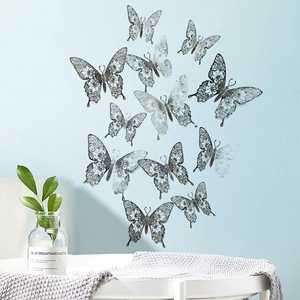 Detailed silver 3D hollow butterfly wall stickers with laser-cut patterns on blue wall