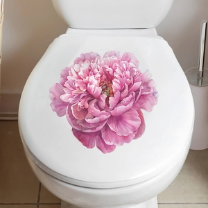 Detail of pink peony flower sticker applied on a white toilet lid for bathroom decoration
