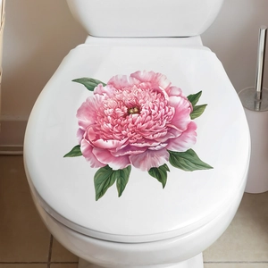 Detail of pink peony flower wall sticker applied on a white toilet lid in modern bathroom