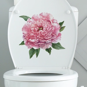 Detailed view of pink peony flower wall sticker applied on a white ceramic toilet lid