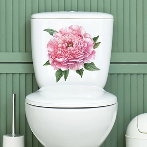 Close-up of pink peony floral sticker applied on white toilet tank with green background
