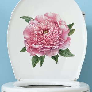 Detail of pink peony flower wall stickers on a white toilet lid for bathroom decor