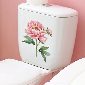 Detail showing pink peony flower decals applied on a white ceramic bathroom toilet tank