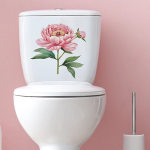 Detail of pink peony flower wall stickers applied on a white ceramic toilet tank surface
