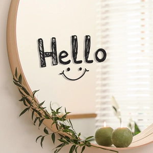 Close-up of decorative Hello and smile face sticker on a round wooden frame mirror